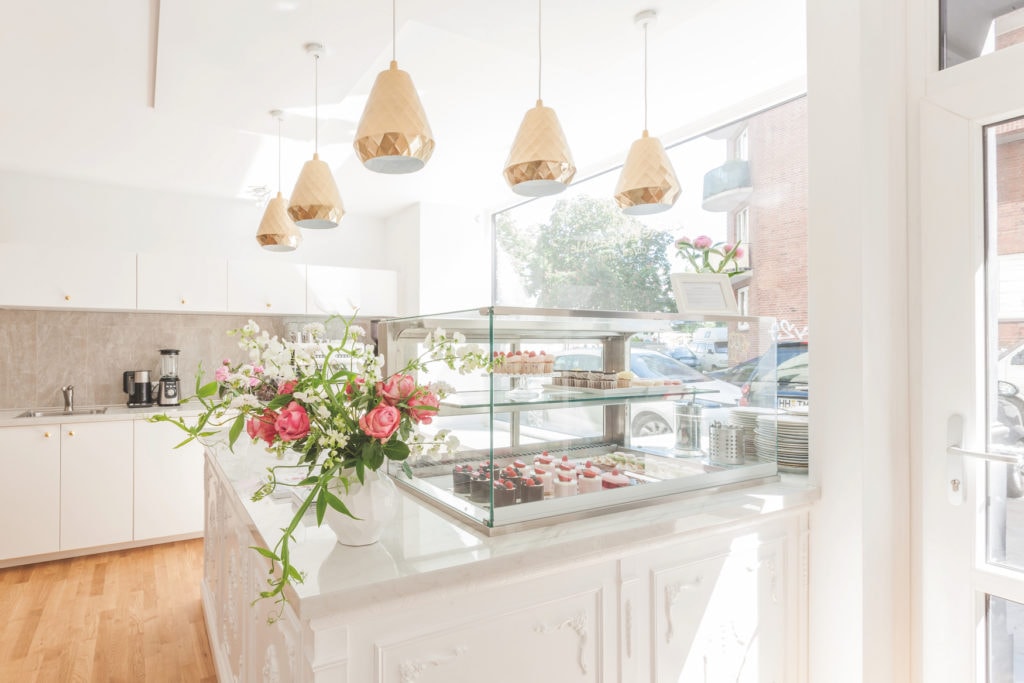 Cake counter with small delicacies in the sugar monarchy, a café in Hamburg