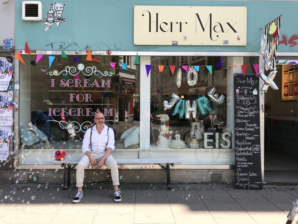 Herr Max, the owner, sitting in front of his beautiful cafe