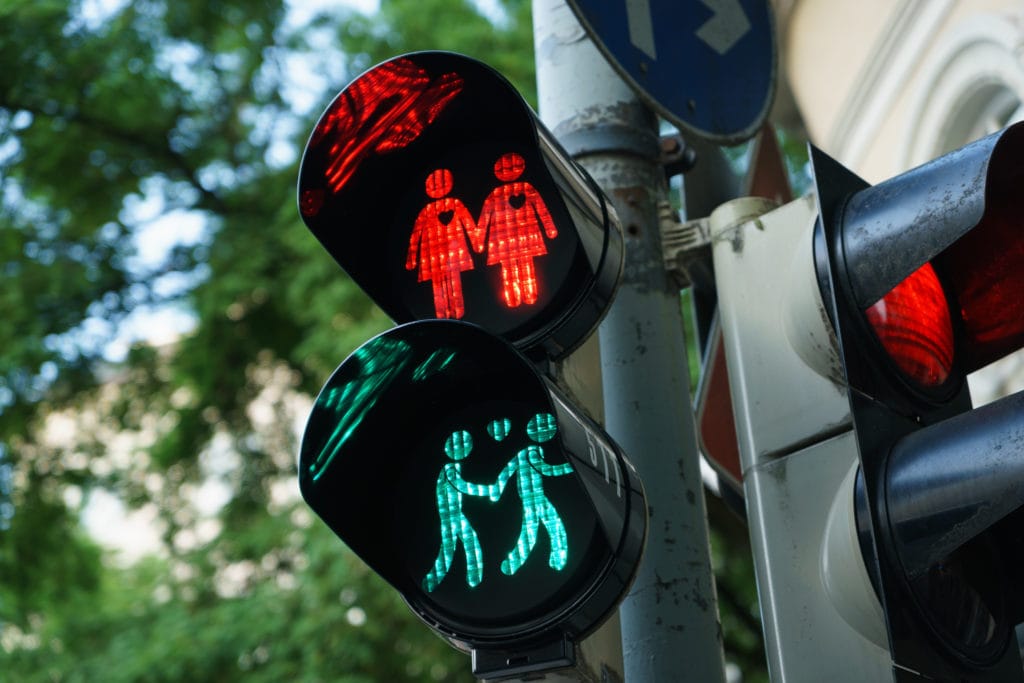 Homosexual and hetero couples in love at pedestrian lights based on the Viennese model in Munich's Glockenbachviertel
