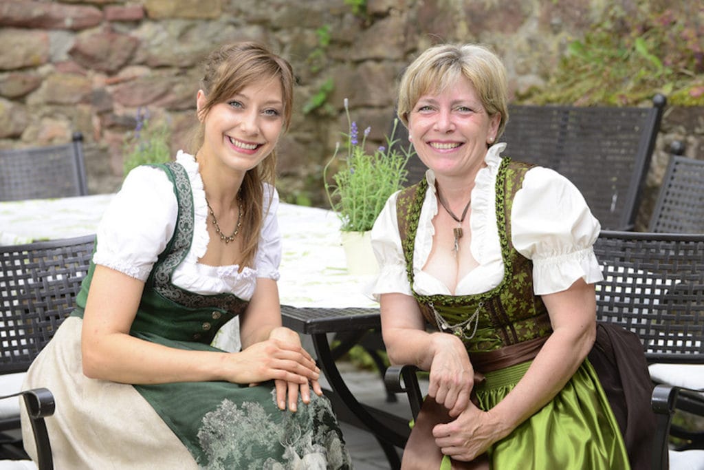 Barbara and Erika Bear in dirndl at one table