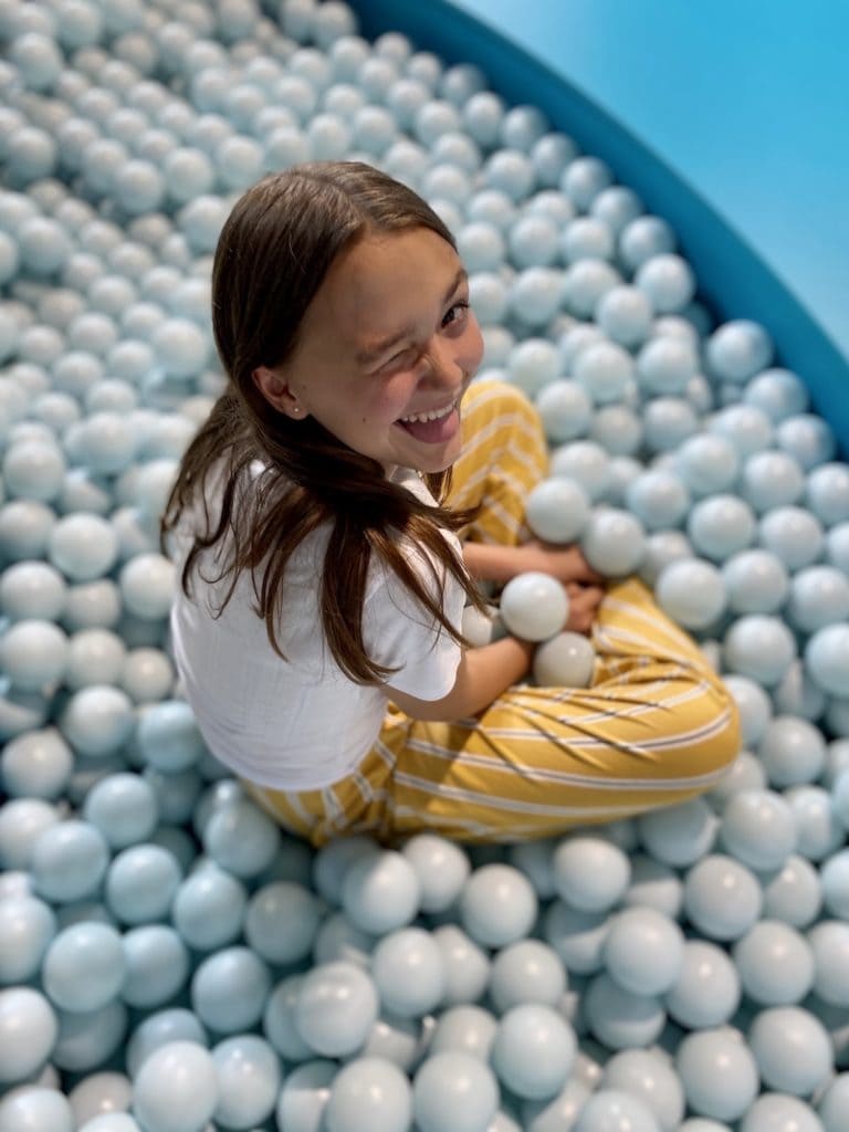 Girl poses in a ball pit