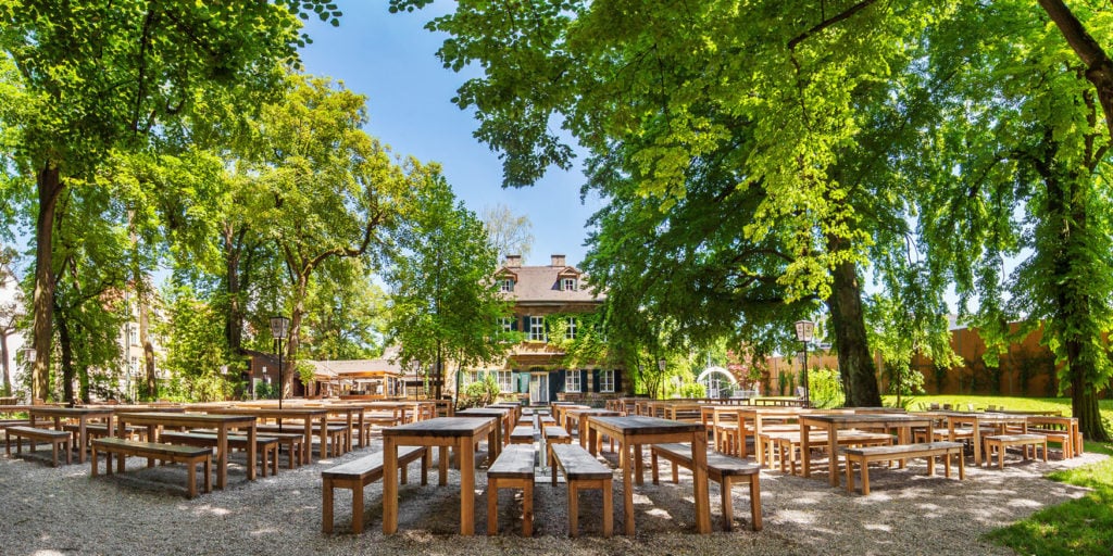 Riegele beer garden with empty benches in front of the manor house