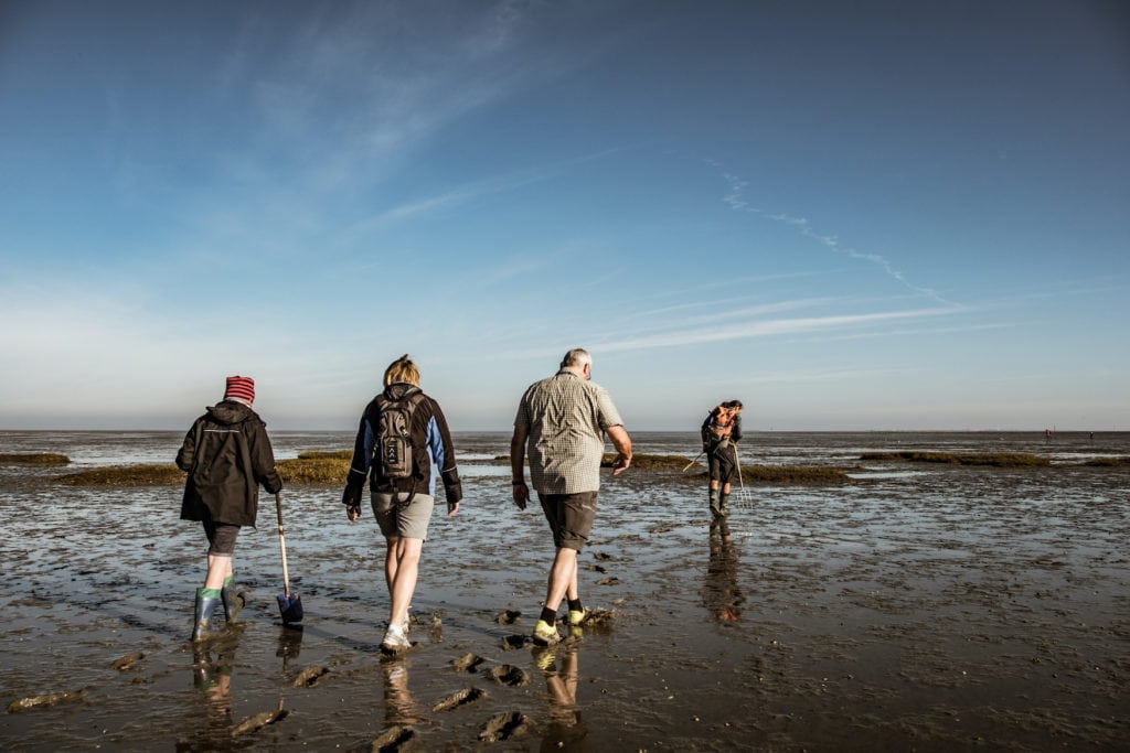 Family on a mudflat hike in Northern Germany