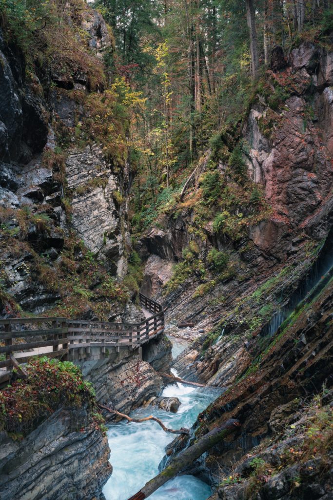 Beautiful Wimbachklamm gorge with wooden path in autumn colors, Ramsau bei Berchtesgaden in Germany