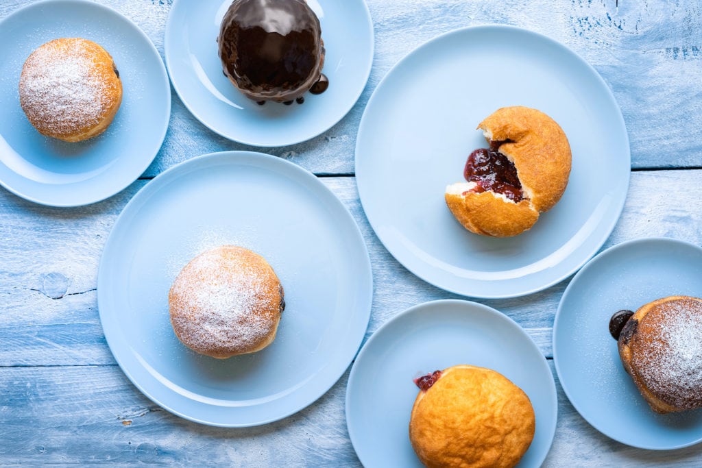 Various doughnuts filled with jam, chocolate or vanilla pudding