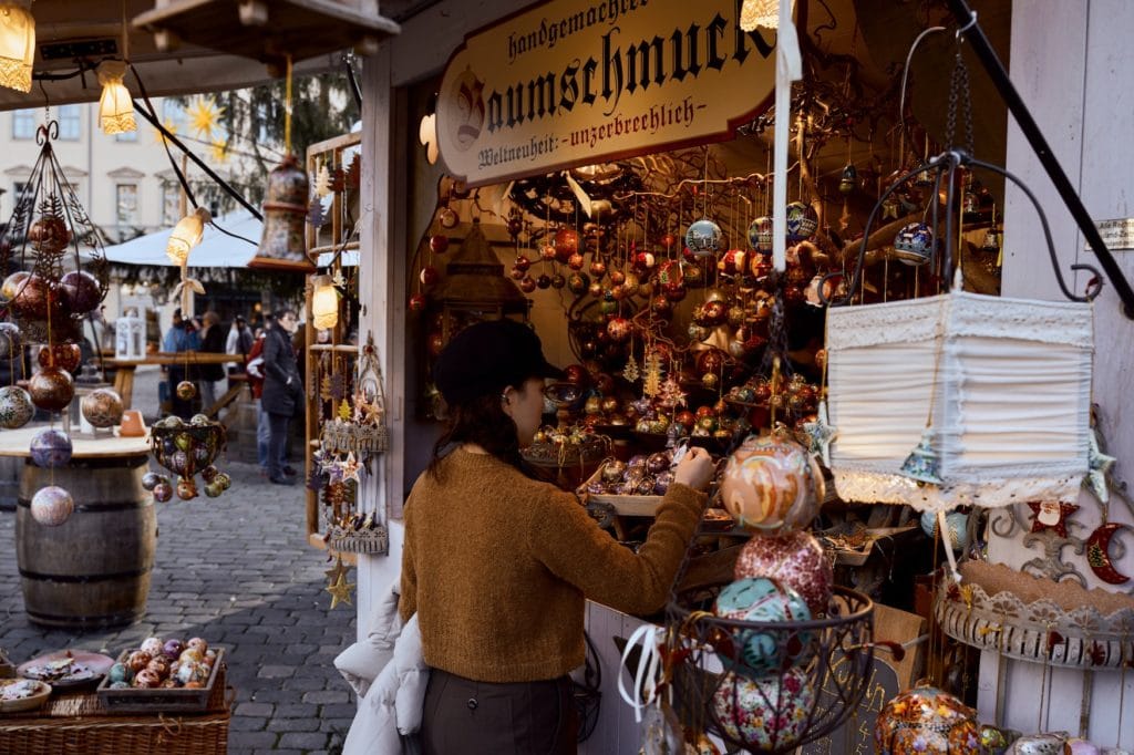 Woman at a little shop on Christmas market in Germany