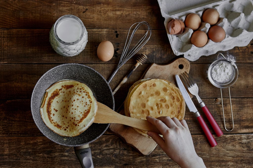 Woman frying pancakes