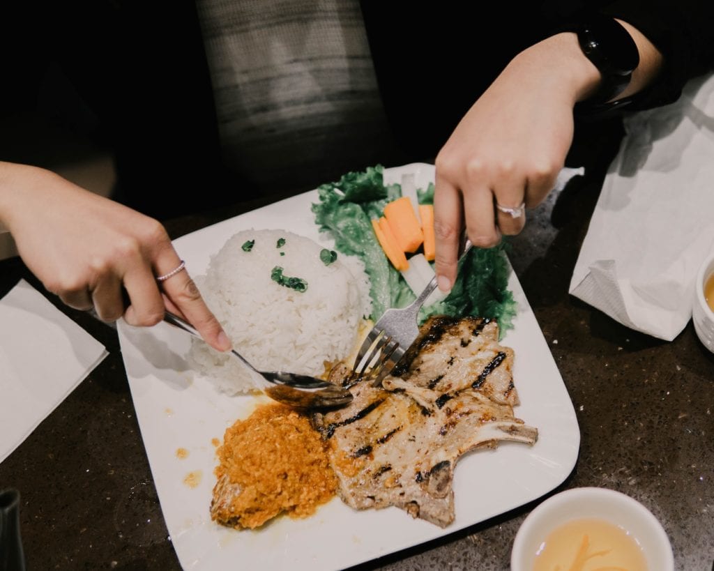 Eating dinner with fork and spoon