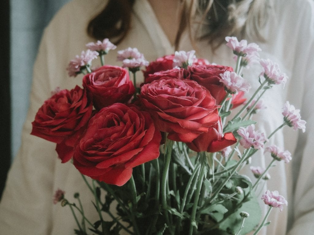 Woman holding bouquet of flowers