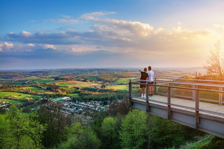 Two boys stand on viewing platform and enjoy the view over Saarland