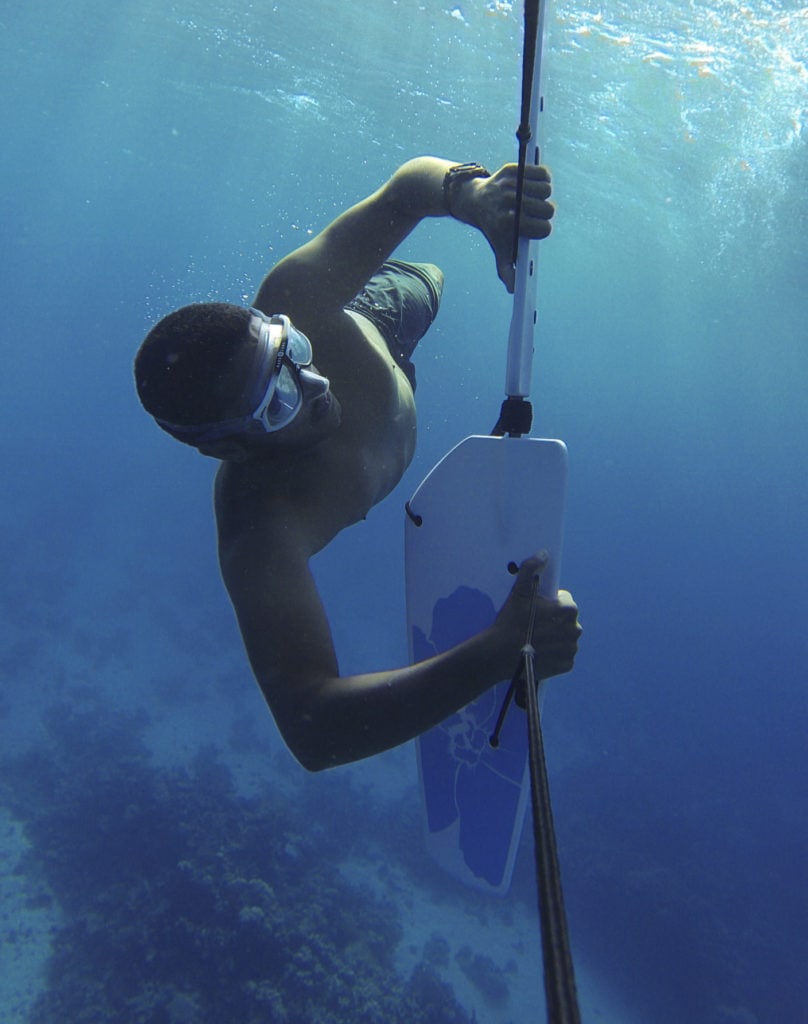 Man under water doing subwing