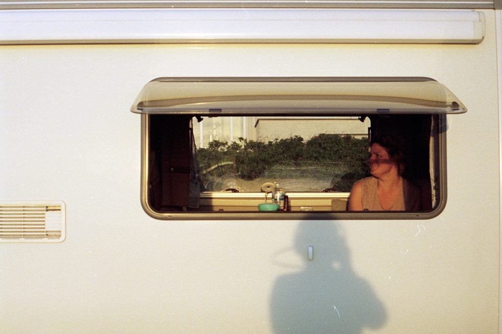 Woman sitting in a caravan on a campsite in Hesse