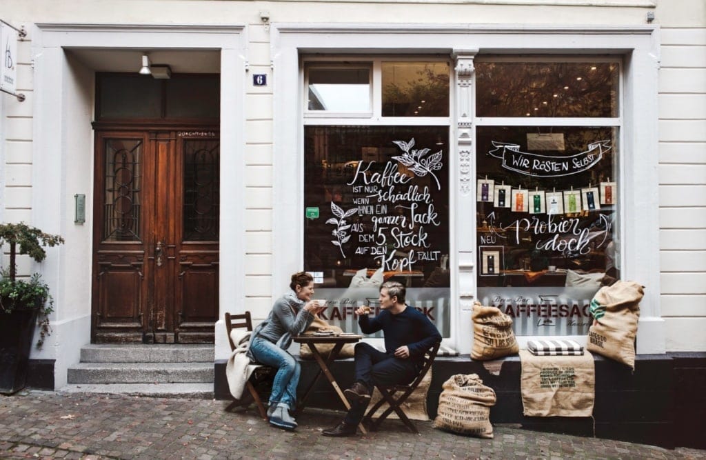 People drinking coffee in front of a coffee roaster in Baden Württemberg