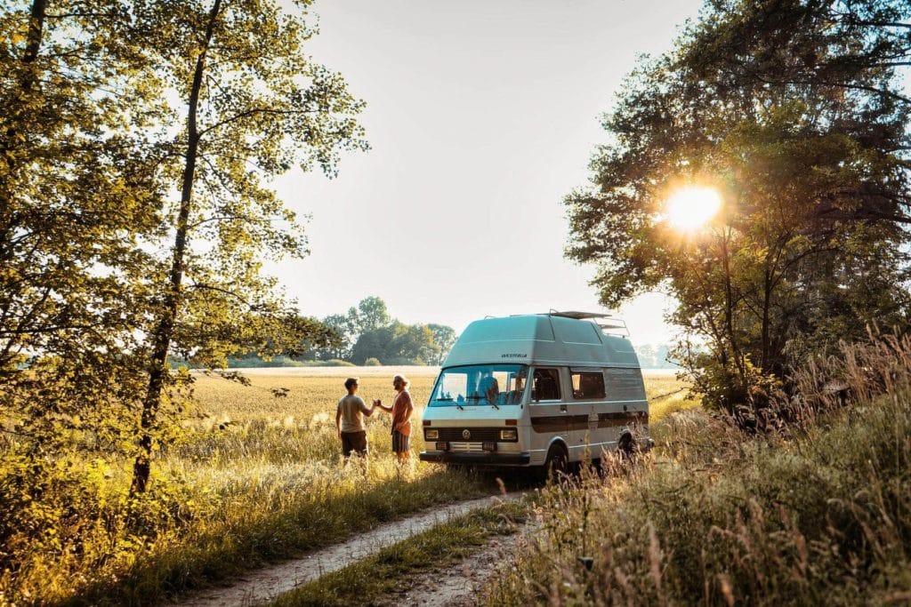 Camper standing in German nature at sunset