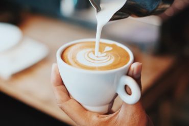 A barista is doing Latte Art