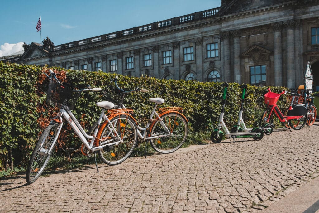 Fahrräder und E-Bikes stehen an Hecke in Berlin