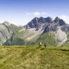 Wanderer auf Wanderroute in Oberstdorf in Bayern mit den Allgäuer Alpen im Hintergrund
