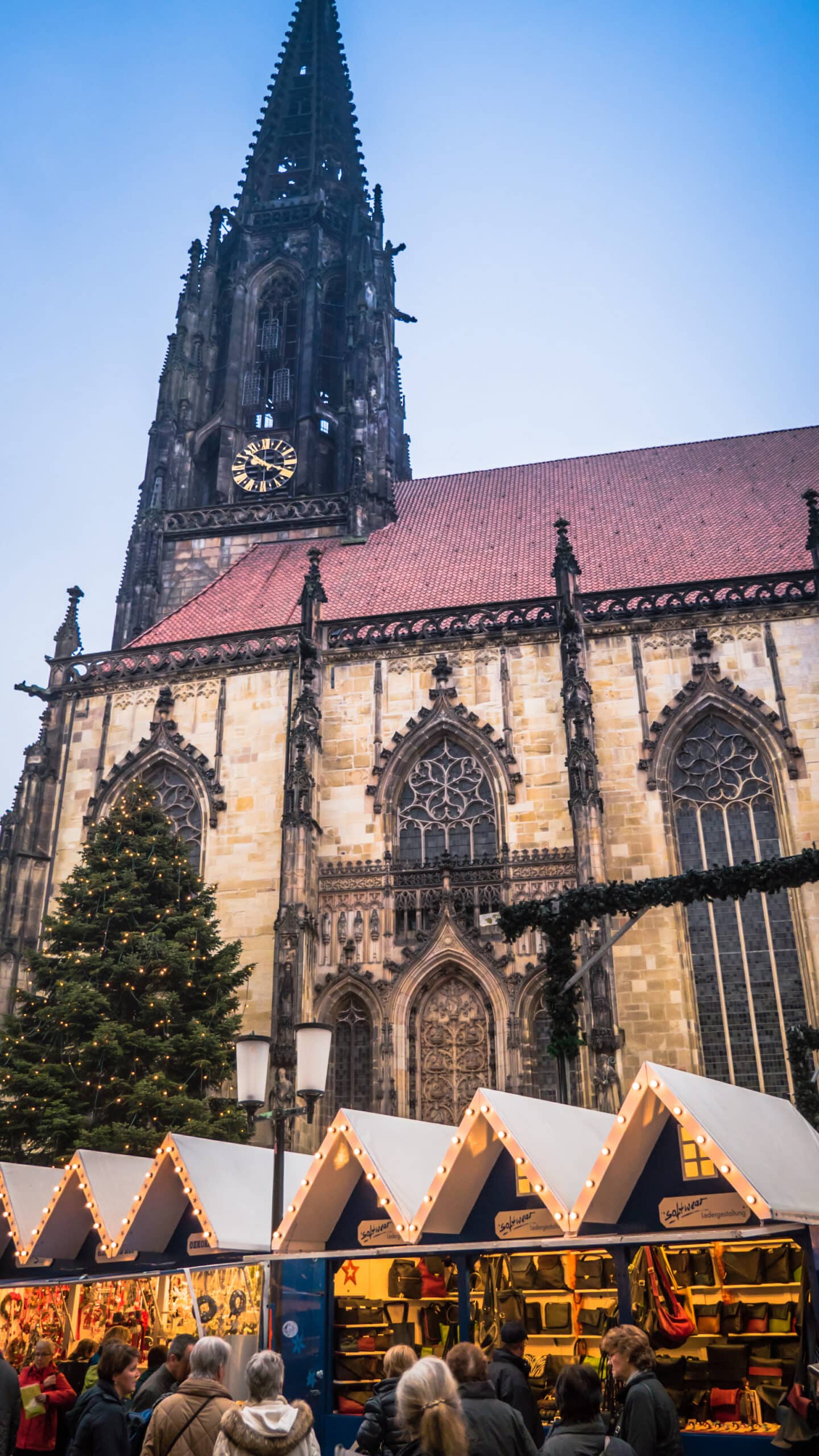 Traditional German Christmas  market during the Christmas time at Domplatz with the St Paulus Dom downtown Muenster, Germany.