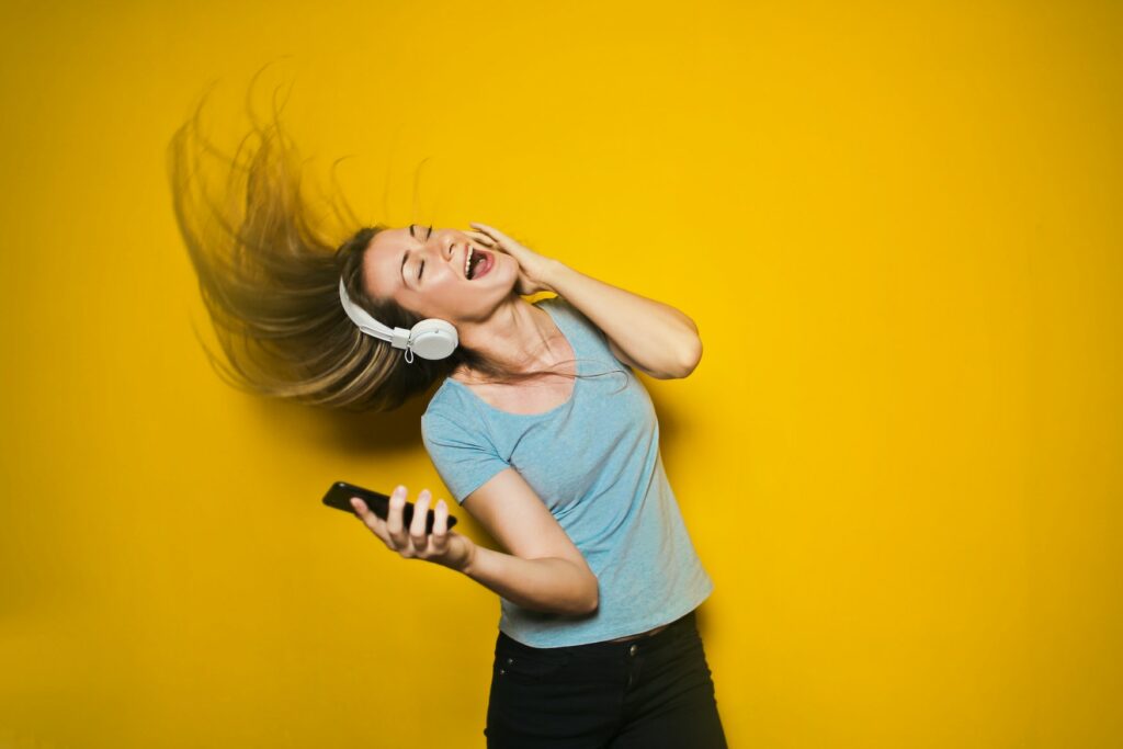 Woman has headphones on and dances to the music