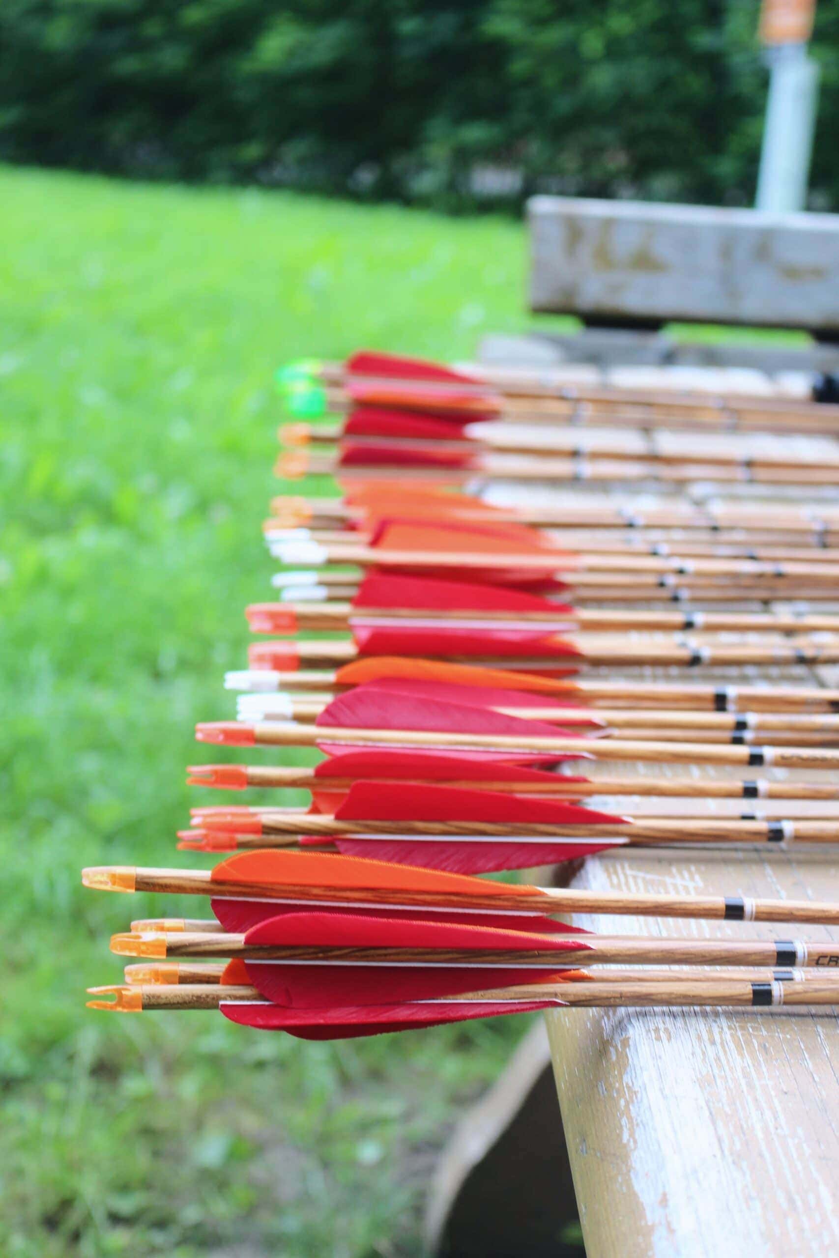 Arrows for archery lie on wooden table