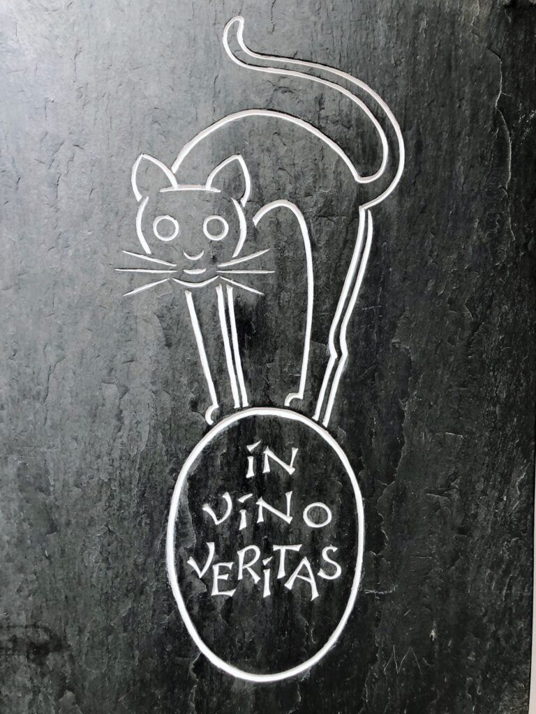 Cat on wine barrel with lettering "In Vino Veritas