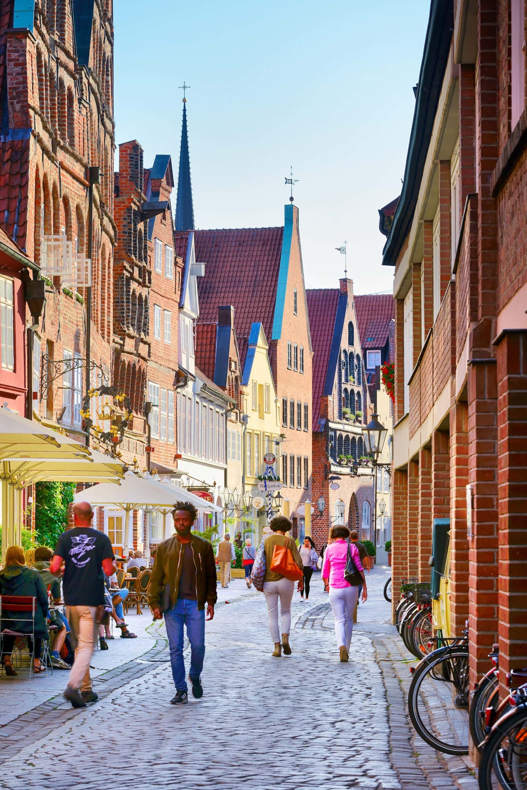 Typical architecture on Heiligengeiststraße in the old town of Lüneburg with tourists.