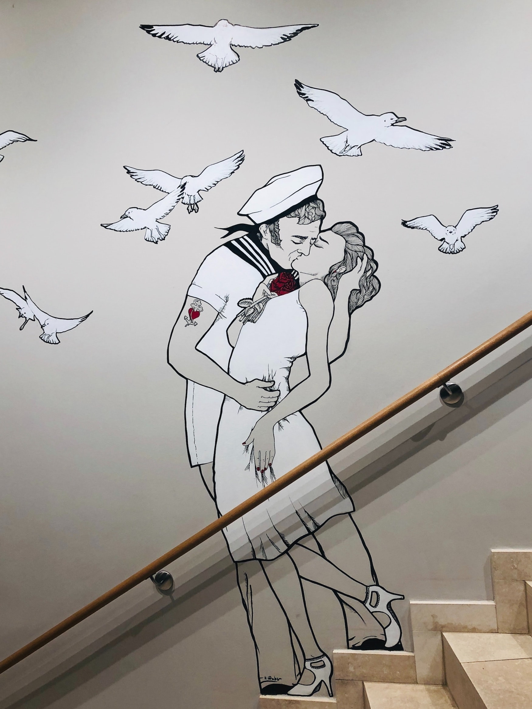 Street art in Hamburg with two people kissing, a sailor and a woman