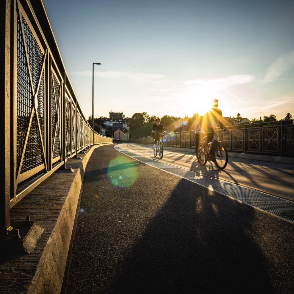 Cyclists through Wuppertal in the evening at dusk