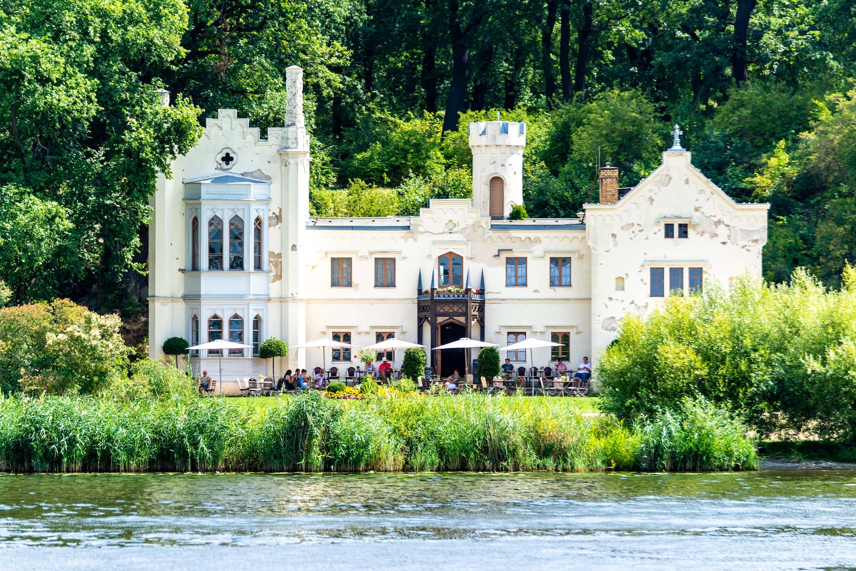 Small castle of the Park Babelsberg in Potsdam, which is used as a restaurant. The small castle was photographed from the water and is called garden hous