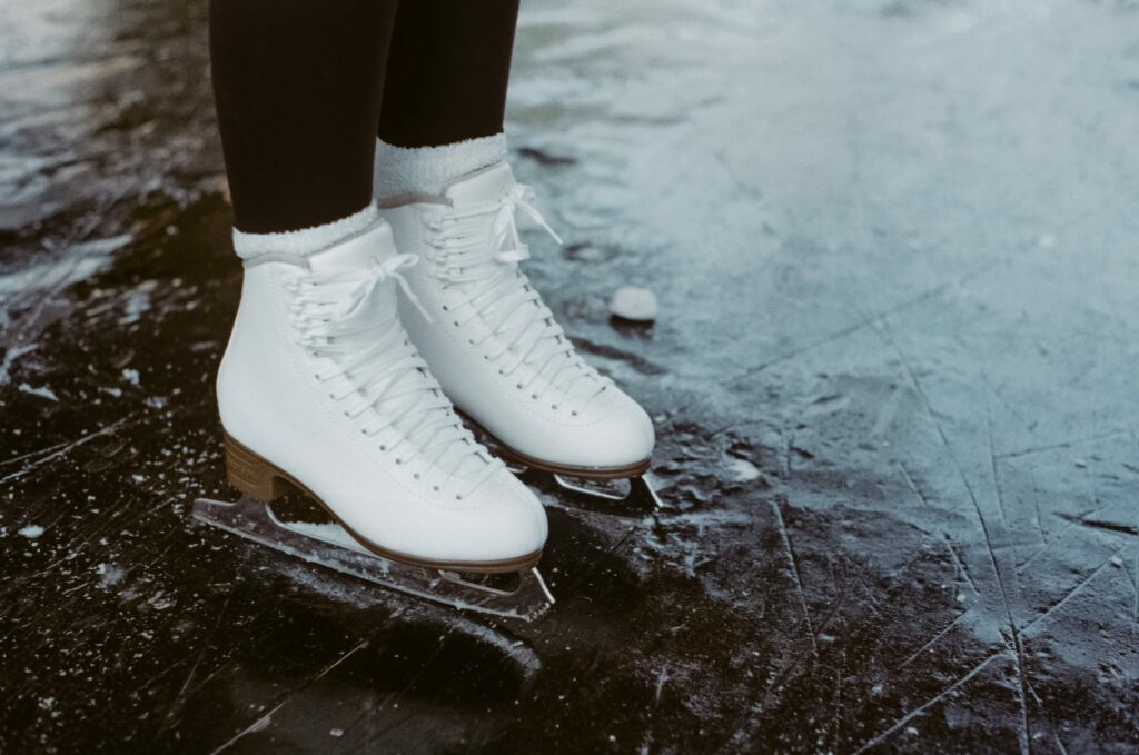 White skates on frozen ice