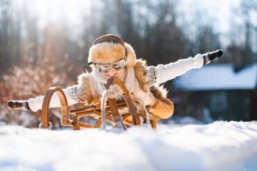 Child on a sled having fun