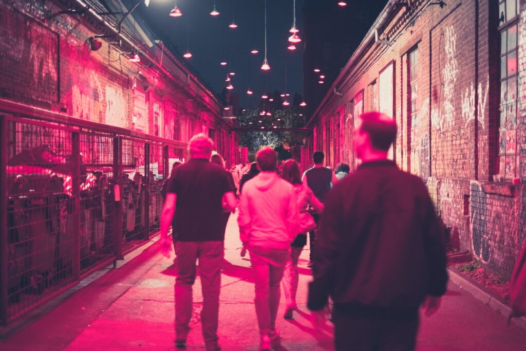 people walking on street at night in nightlife of Berlin