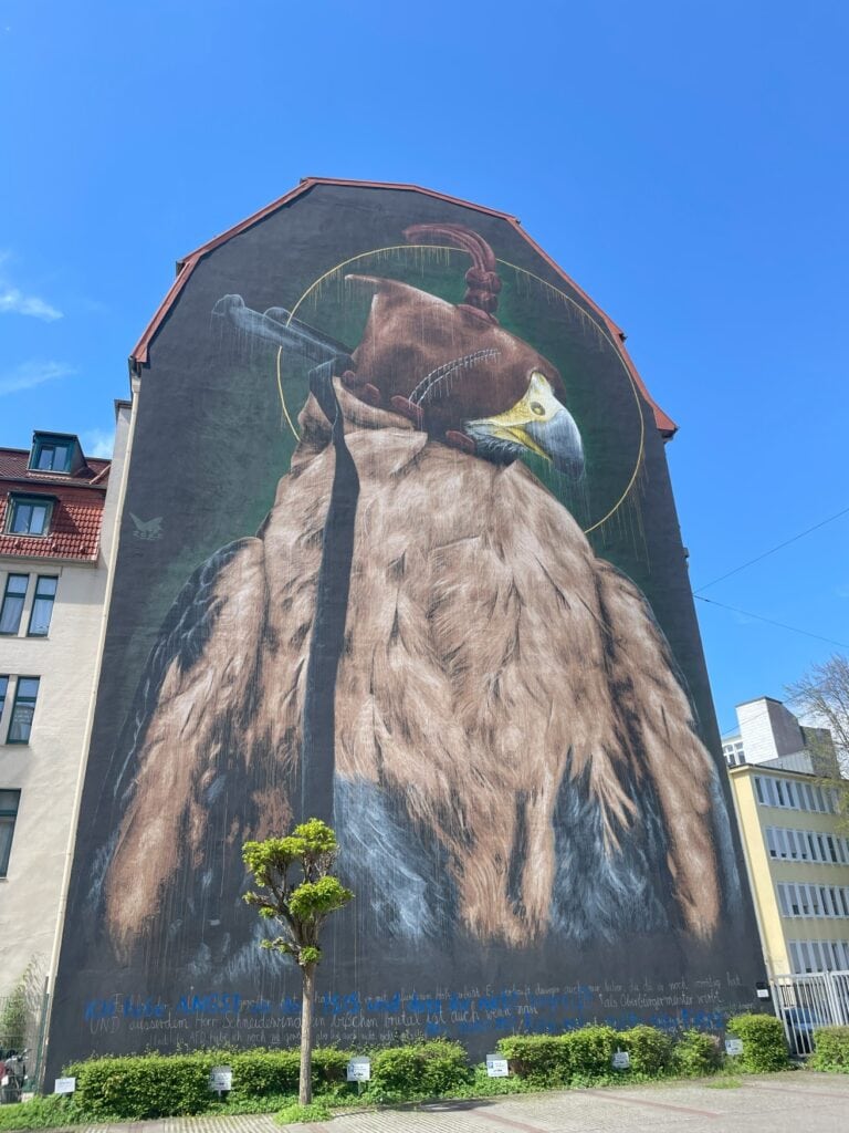 Ein haushohes Wandmural zeigt einen Jagdfalken mit Haube
