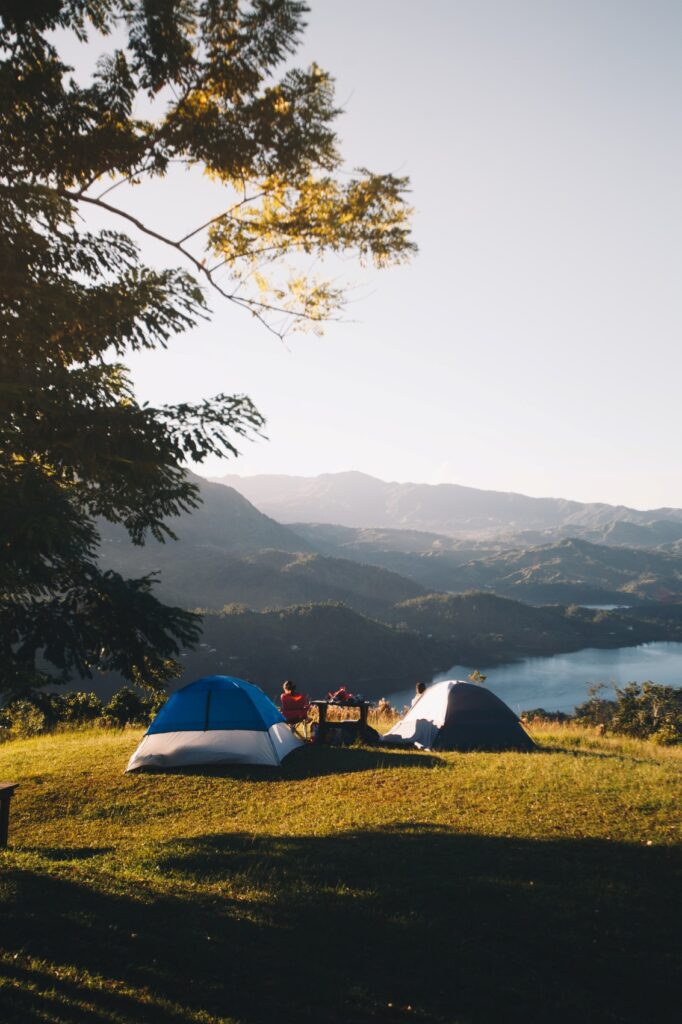 Two tents stand high above a mountain lake