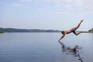 A man takes a header into a lake in the Duchy of Lauenburg