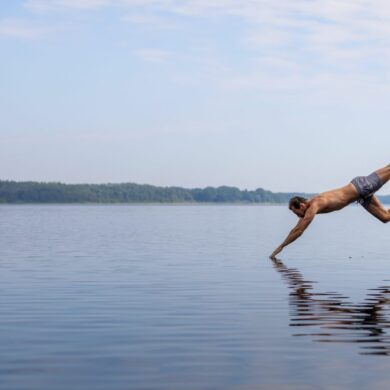 A man takes a header into a lake in the Duchy of Lauenburg