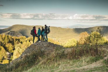 Family standing on a mountain top in the Zittau Mountains