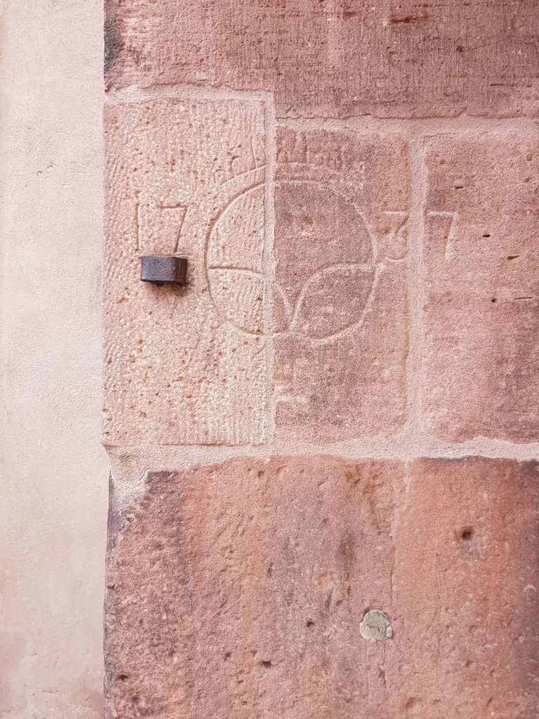 An engraved sacle for pretzels in the wall of the Heiliggeistkirche