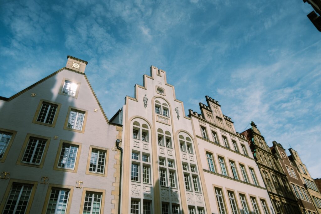 View of some facades against a blue sky at Prinzipalmarkt in Münster