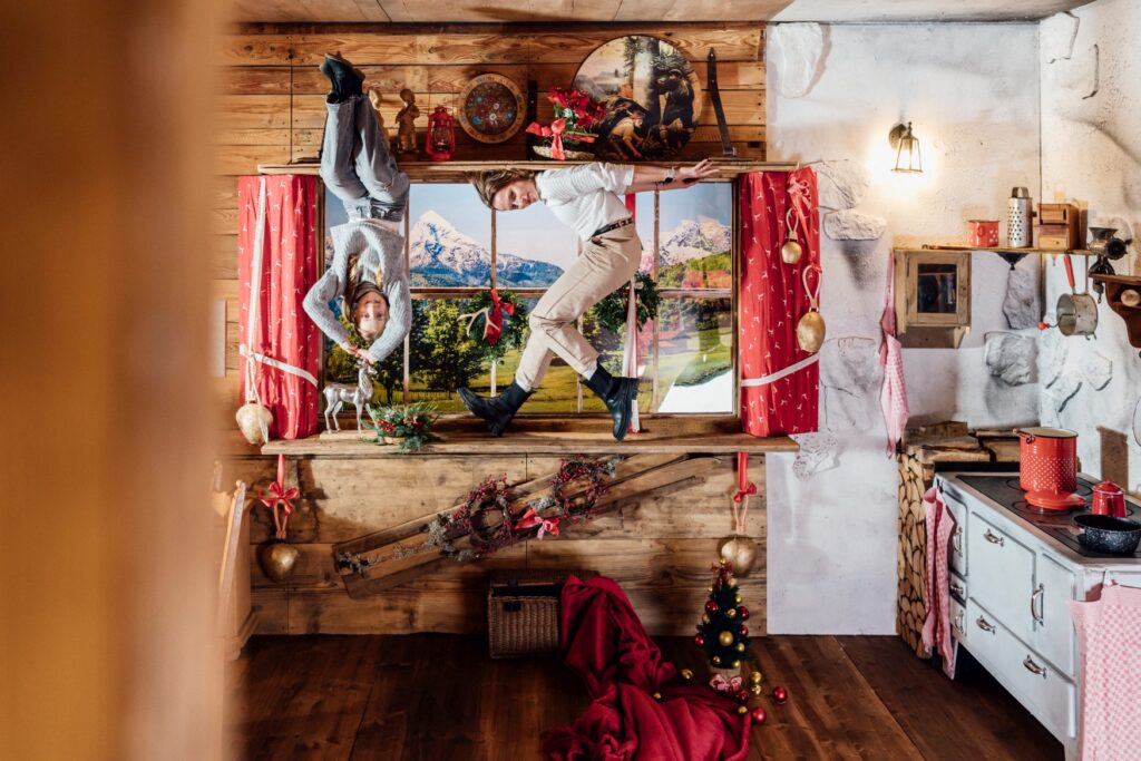 In a photo illusion in the "Magic Bavaria" museum in Munich, a woman and a child sit upside down in a mountain hut