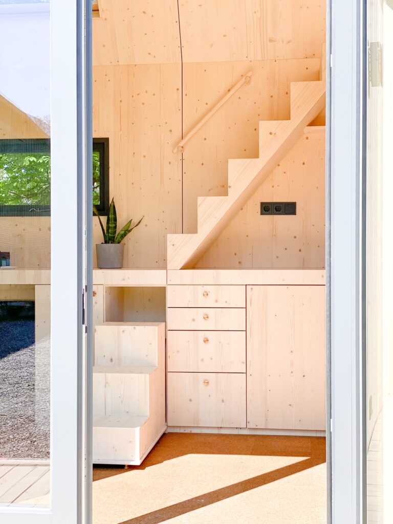 Interior of a Green Tiny House with sideboard and staircase