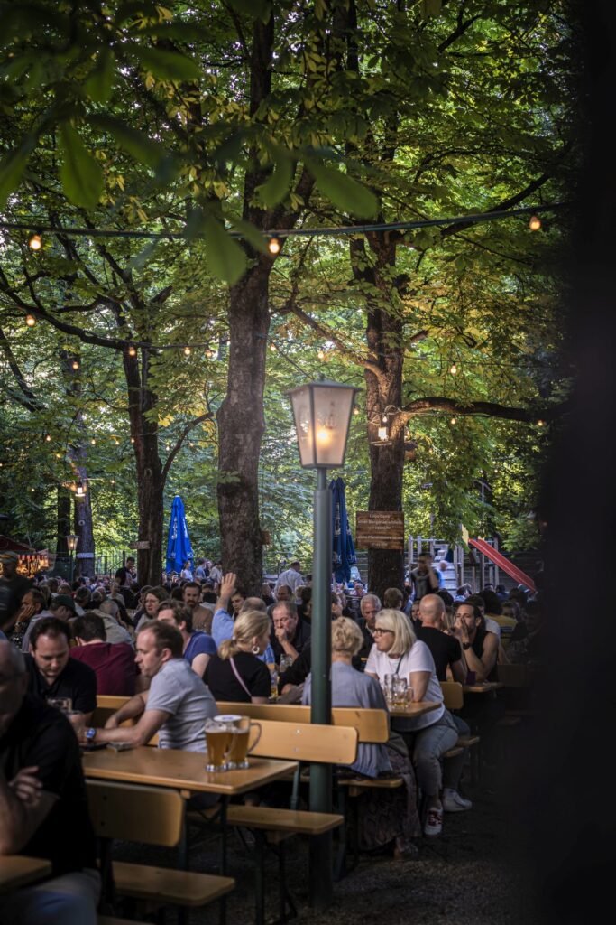 People sitting in a wooded beer garden