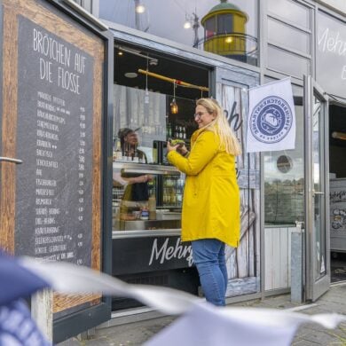 A woman in a Frisian mink orders a vegan fish sandwich at Mehrfisch in Eckernfoerde