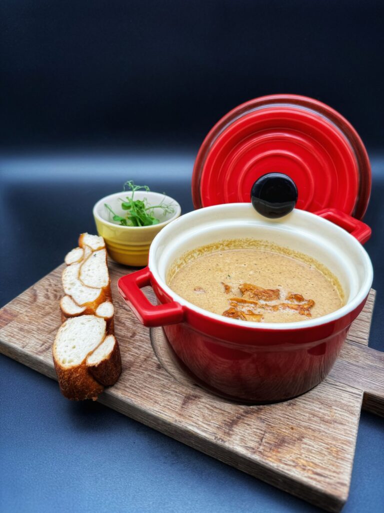 A chanterelle soup in a decorative casserole dish