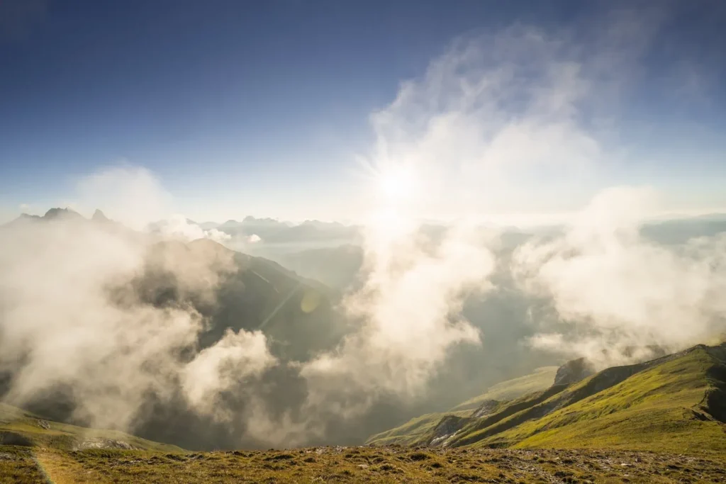 The fog lifts over a valley in the Oberstdorf Alps.