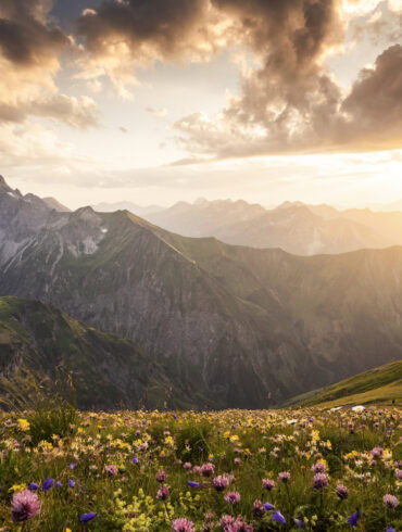 A few houses can be seen in a valley in the Allgäu region near Oberstdorf in the fall.