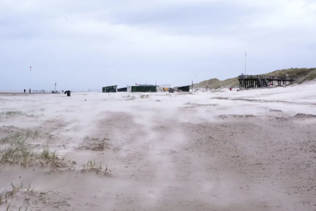 On the beach of Amrum, sand is blown up by strong winds.