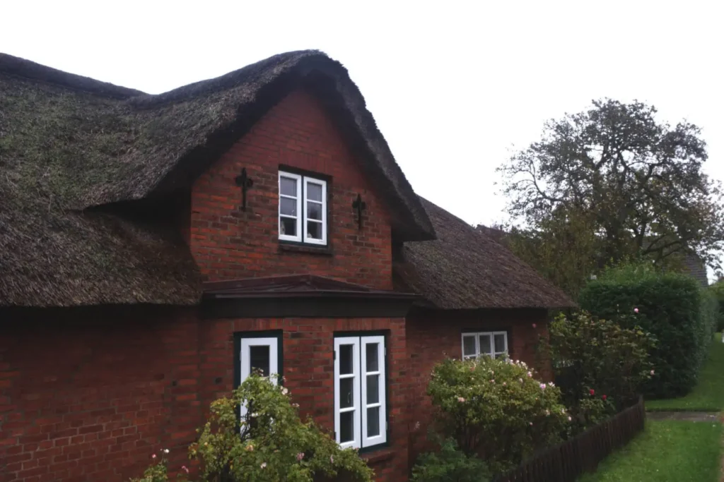 A typical Frisian house with red tiles and a thatched roof