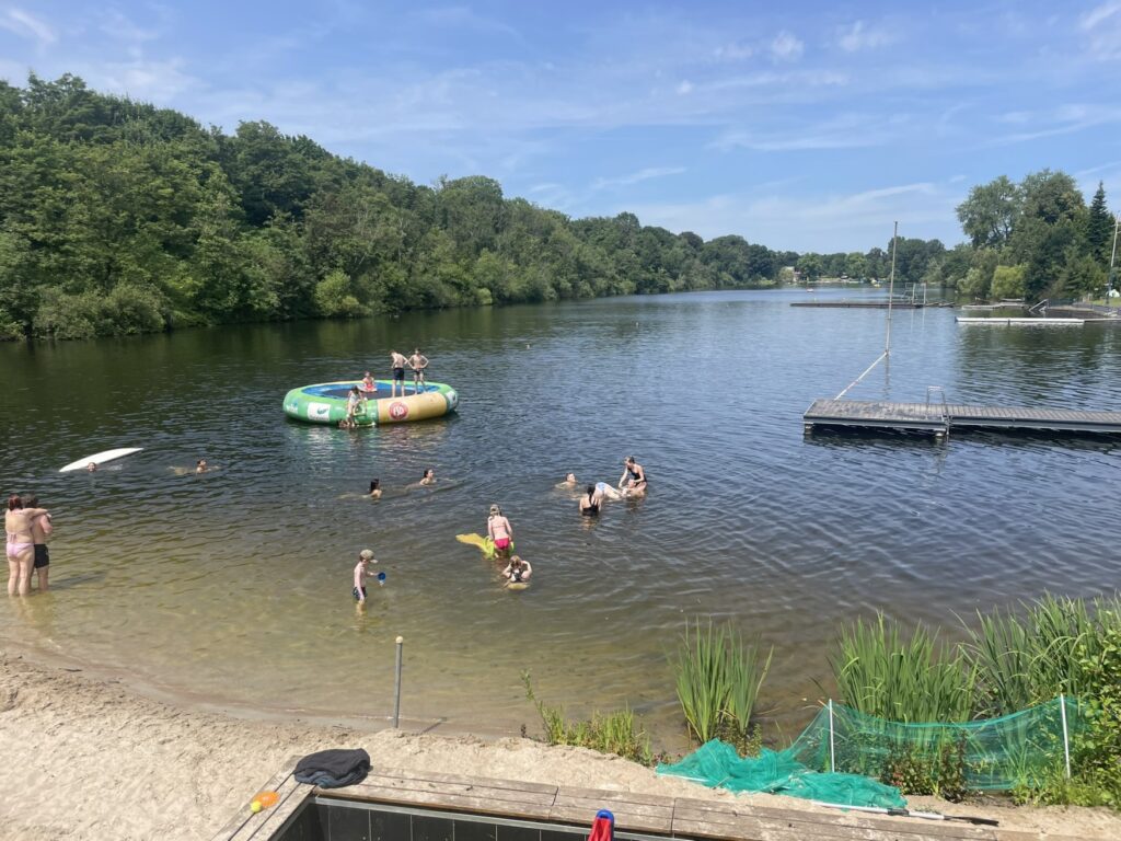 People enjoying the sun in one of the lakes of the Six Lakes