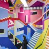 A colorful mural at the Wow Museum in Munich that resembles a drawing by M. C. Escher